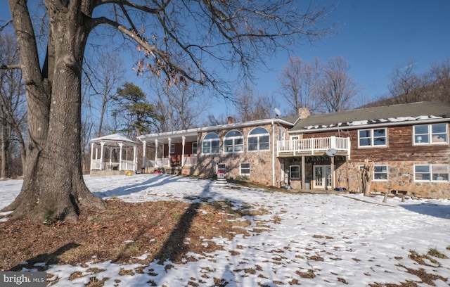 view of snow covered rear of property