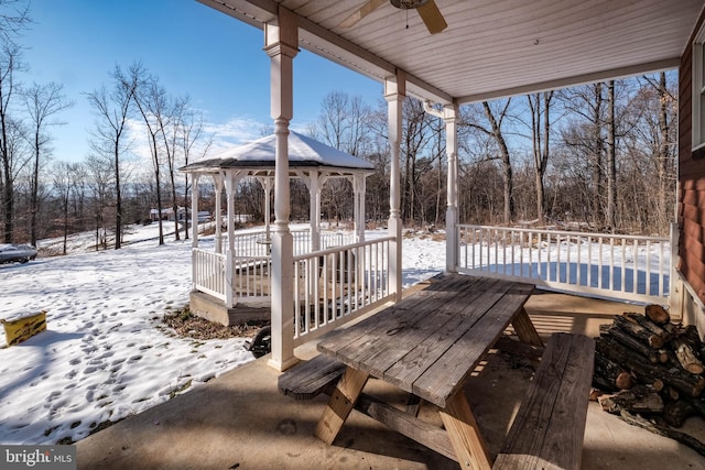 snow covered deck with ceiling fan and a gazebo