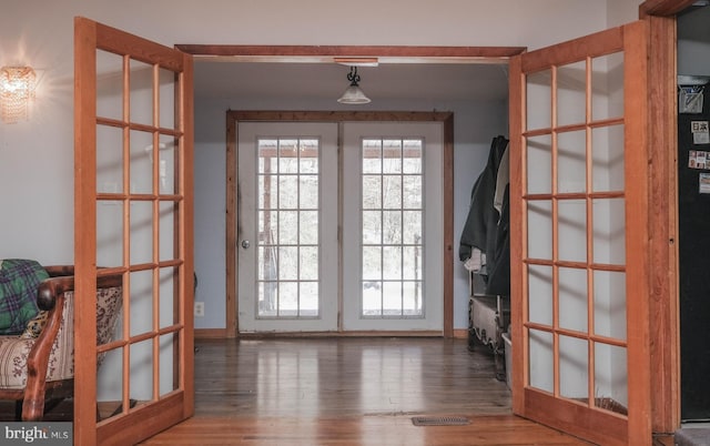 doorway with dark hardwood / wood-style flooring and french doors