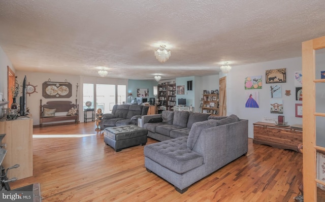 living room featuring a textured ceiling and light hardwood / wood-style flooring