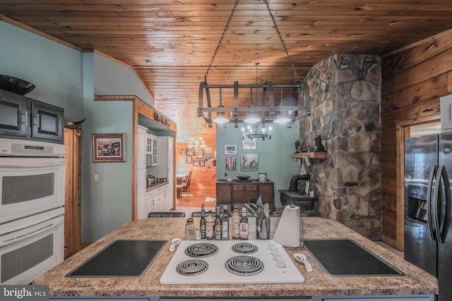 kitchen with light stone countertops, white appliances, wood ceiling, and hanging light fixtures