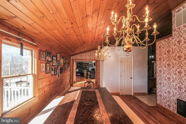 interior space featuring wood ceiling, an inviting chandelier, and light hardwood / wood-style flooring