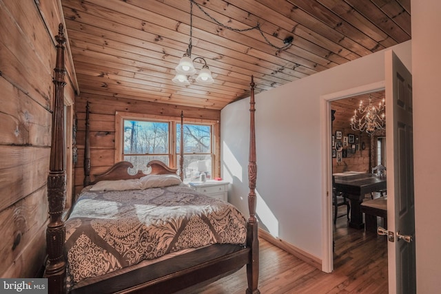 bedroom with wooden ceiling, hardwood / wood-style floors, lofted ceiling, and a notable chandelier