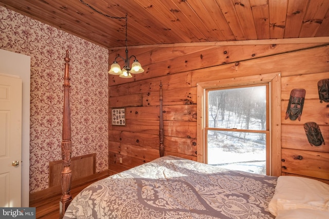 bedroom with vaulted ceiling, wood ceiling, wood walls, and a chandelier