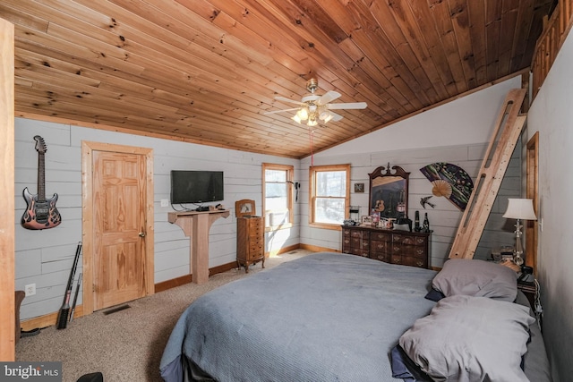 bedroom with ceiling fan, wooden ceiling, wood walls, and vaulted ceiling