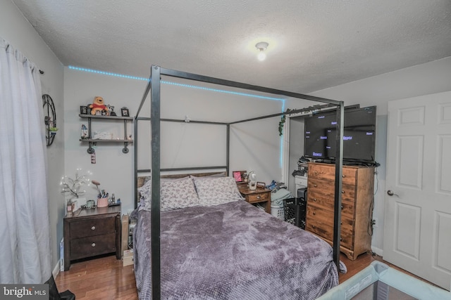 bedroom featuring a textured ceiling and hardwood / wood-style floors