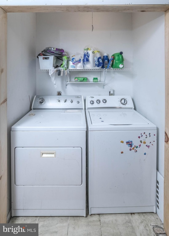 clothes washing area featuring washing machine and clothes dryer