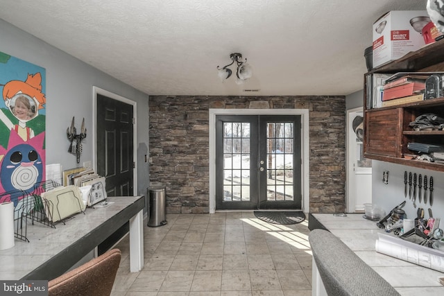 doorway with a textured ceiling and french doors