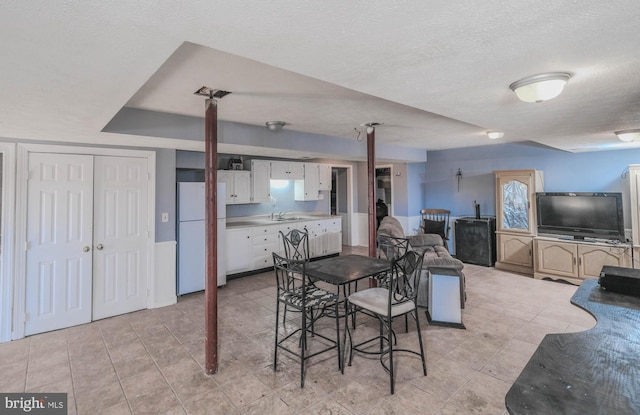 dining room with sink and a textured ceiling