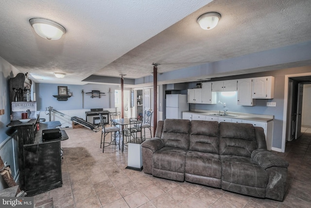 living room featuring a textured ceiling and sink