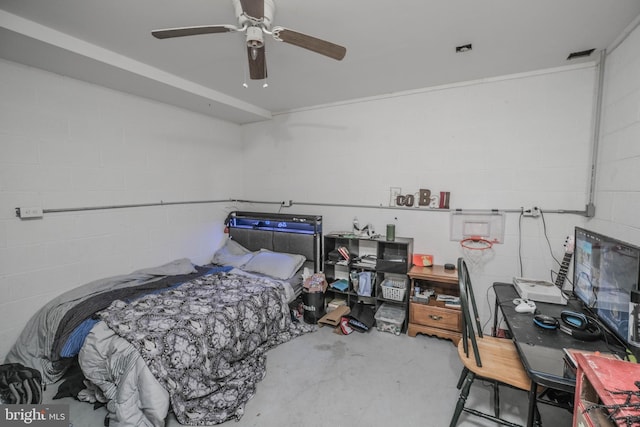 bedroom with ceiling fan and concrete flooring