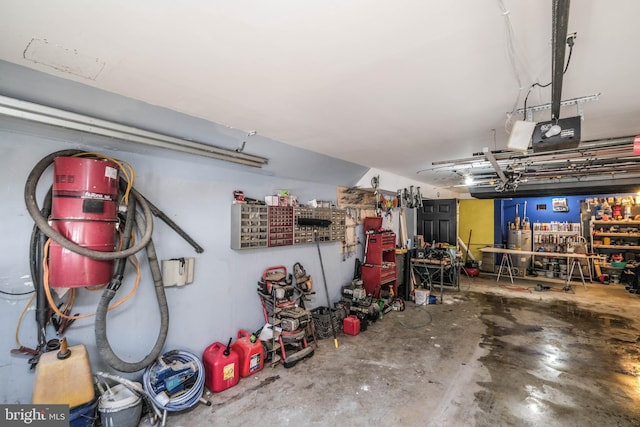 garage with a workshop area and a garage door opener