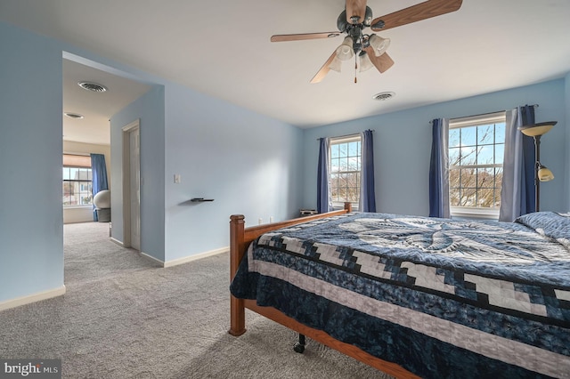 bedroom with a ceiling fan, carpet flooring, visible vents, and baseboards