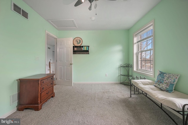 sitting room with attic access, visible vents, baseboards, and light colored carpet