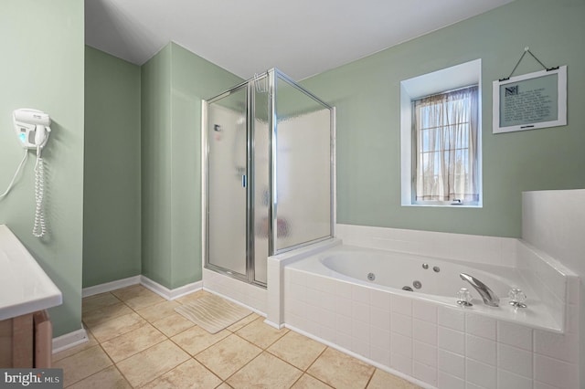 bathroom with a stall shower, vanity, tile patterned flooring, a jetted tub, and baseboards