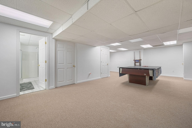 recreation room featuring carpet floors, baseboards, and a drop ceiling