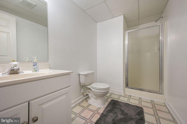 bathroom featuring visible vents, toilet, vanity, a paneled ceiling, and a shower stall