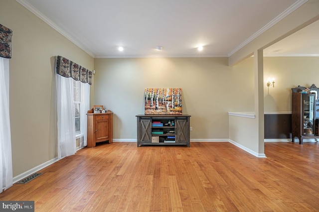 bar featuring baseboards, crown molding, visible vents, and wood finished floors