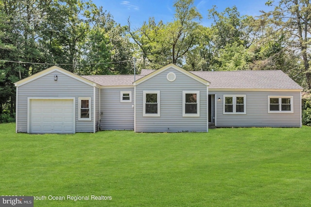 view of front of home with a front yard and a garage