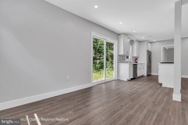 unfurnished living room featuring sink and dark wood-type flooring