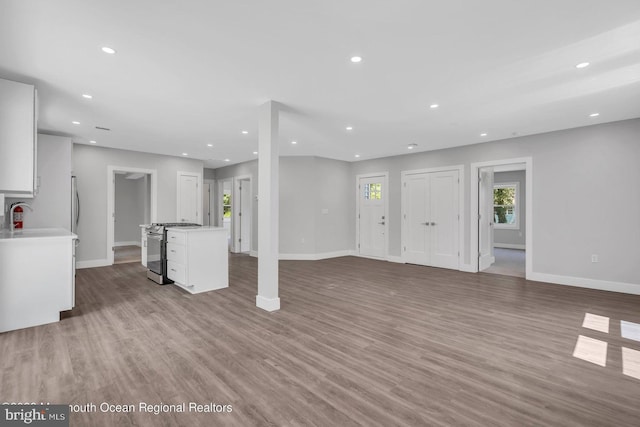 unfurnished living room with light wood-type flooring and sink