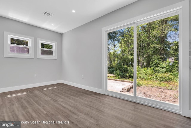 empty room with hardwood / wood-style floors