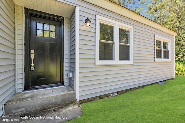 entrance to property with a yard