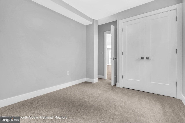 unfurnished bedroom featuring a closet and carpet floors