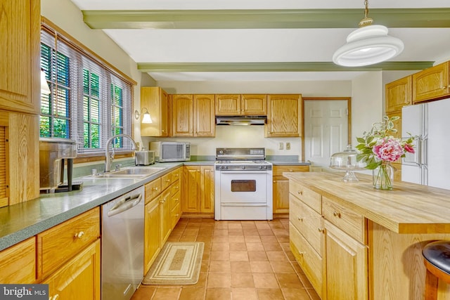 kitchen with butcher block countertops, stainless steel appliances, sink, pendant lighting, and beamed ceiling