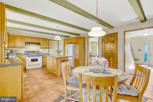 kitchen featuring beamed ceiling, pendant lighting, a center island, and white appliances