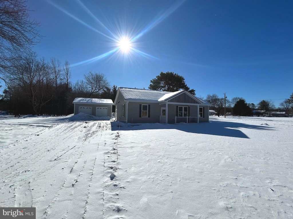 view of front of house with a garage and an outdoor structure