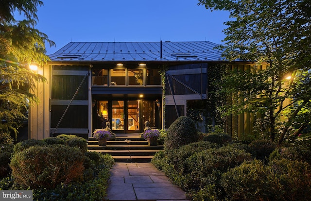 view of back house at dusk