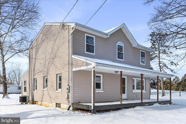 view of front of home featuring covered porch and cooling unit