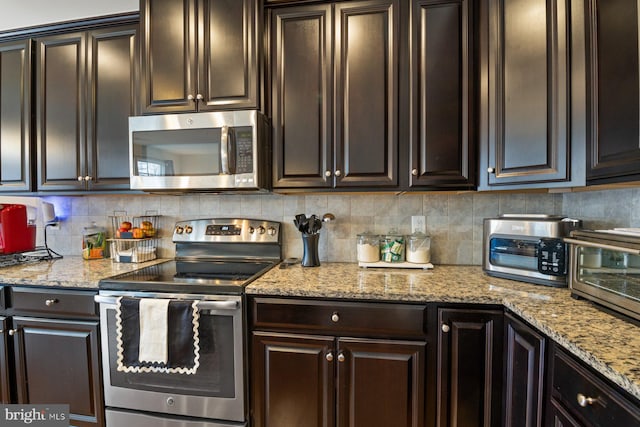 kitchen featuring dark brown cabinets, backsplash, and appliances with stainless steel finishes