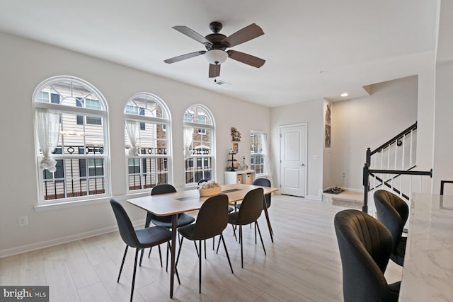 dining area featuring light hardwood / wood-style floors, ceiling fan, and plenty of natural light