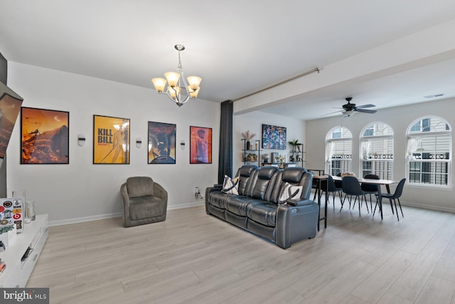 living room with ceiling fan with notable chandelier and light wood-type flooring