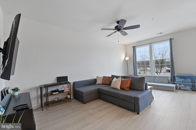 living room featuring ceiling fan and light hardwood / wood-style floors