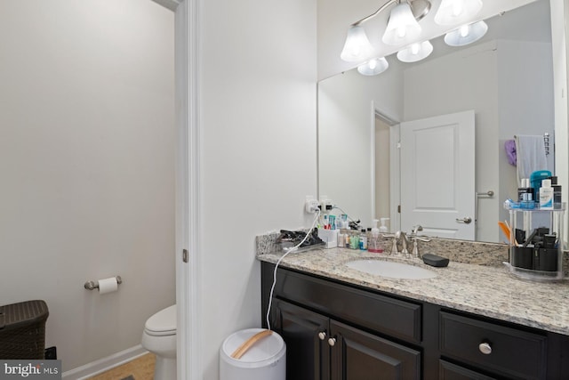 bathroom with toilet and vanity