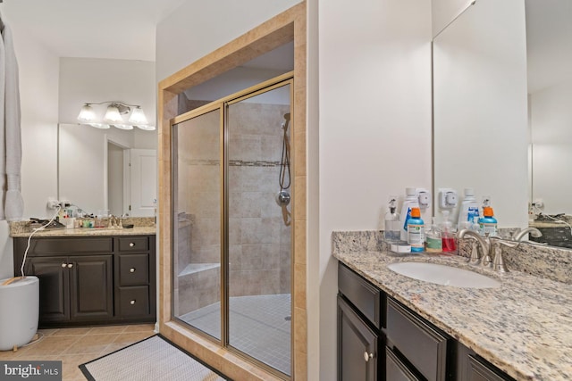 bathroom featuring an enclosed shower, vanity, and tile patterned flooring