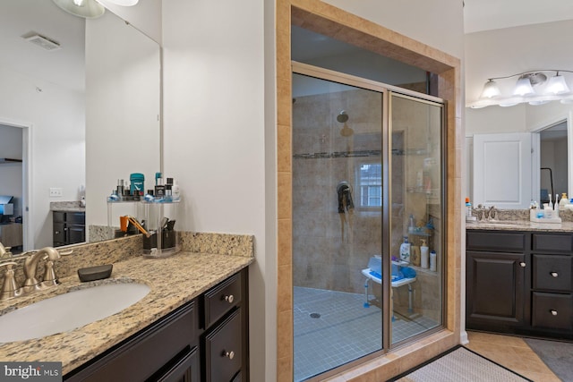 bathroom featuring tile patterned floors, walk in shower, and vanity