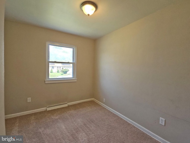 spare room featuring carpet floors and baseboard heating