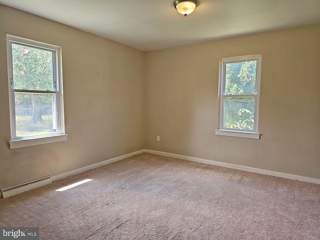 carpeted empty room featuring a baseboard radiator