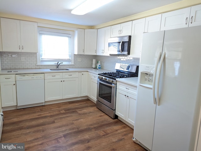 kitchen featuring stainless steel appliances, white cabinetry, sink, and tasteful backsplash