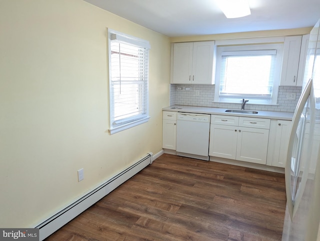 kitchen with white appliances, sink, a baseboard heating unit, and white cabinetry