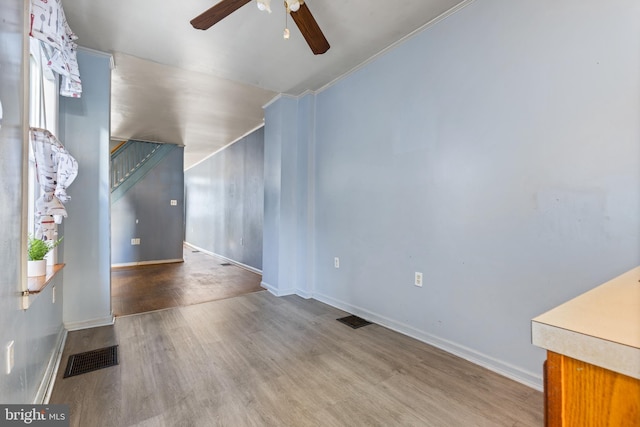 unfurnished living room featuring ceiling fan and wood-type flooring