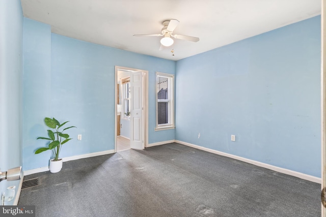 empty room featuring dark colored carpet and ceiling fan