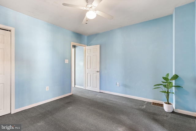 carpeted spare room featuring ceiling fan