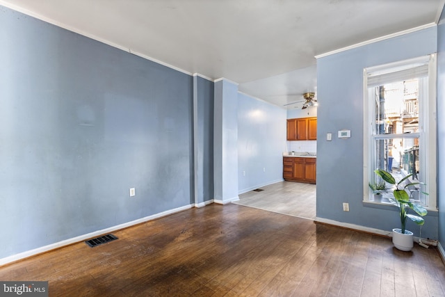 empty room featuring ceiling fan, ornamental molding, and light hardwood / wood-style flooring