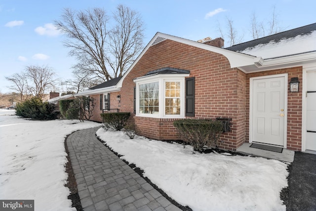 view of snow covered exterior featuring a garage