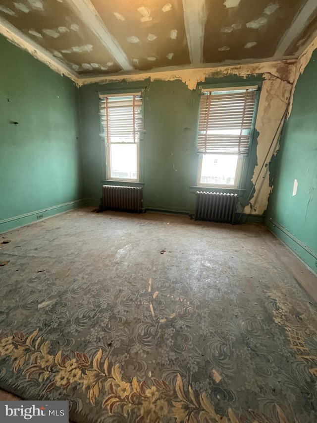 spare room featuring radiator heating unit